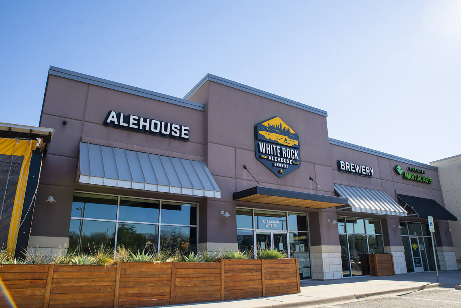 Wooden planters decorate the front of White Rock Alehouse in Dallas, TX.