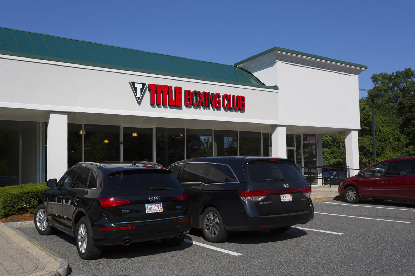 SUVs and minivans parked at Title Boxing Club in Burlington, MA.