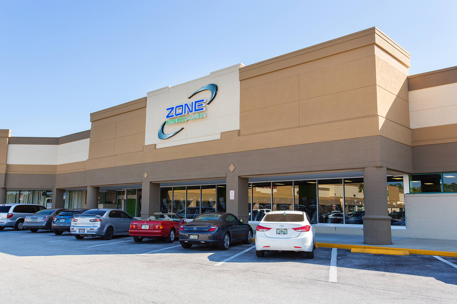 Cars parked in front of Zone Fitness gym in New Port Richey, FL.