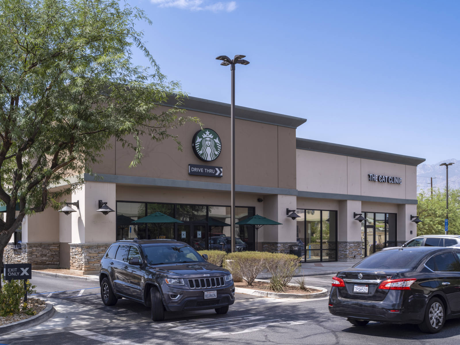 Black SUV pulling out of drive thru at Starbucks in Cathedral City, California