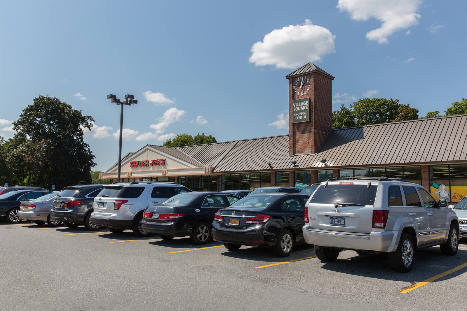 Cars parked, lined up at Village Square Shopping Center